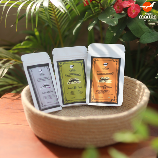 Nilgiri Marten Discovery Kit with Tellicherry Pepper, Idukki Cardamom, and Lakadong Turmeric pouches in a basket