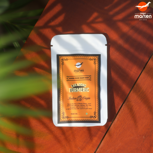 Marten Spices Lakadong turmeric package on a wooden surface with plant shadows